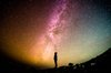 A person's silhouette against a backdrop of a starry sky